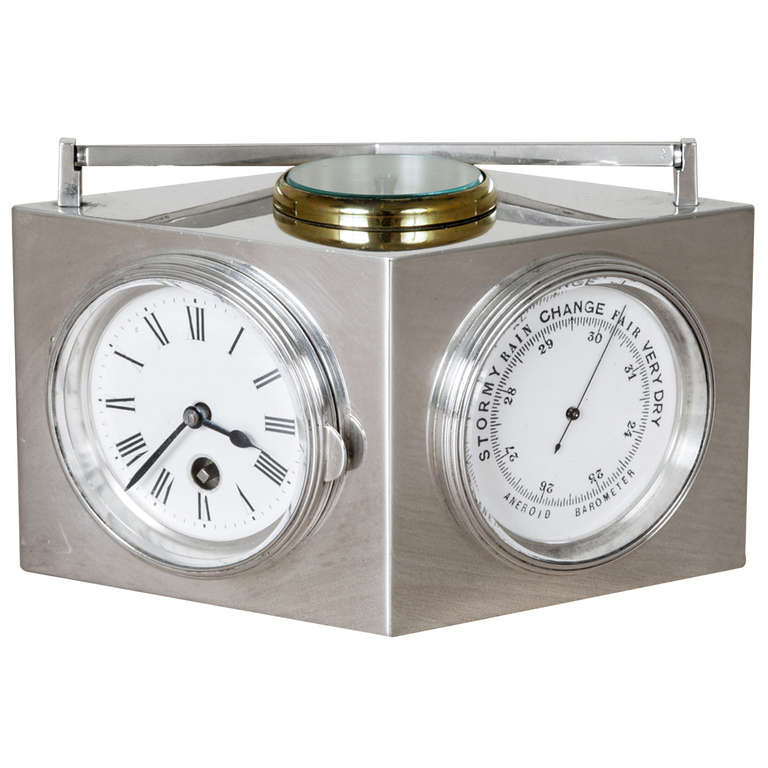 This sterling silver lozenge-shape combination clock with attached handle was made in France circa 1910. It has a dial to each side. A clock with a Swiss movement; a barometer; a Fahrenheit thermometer; and a Centigrade thermometer; unusually, there