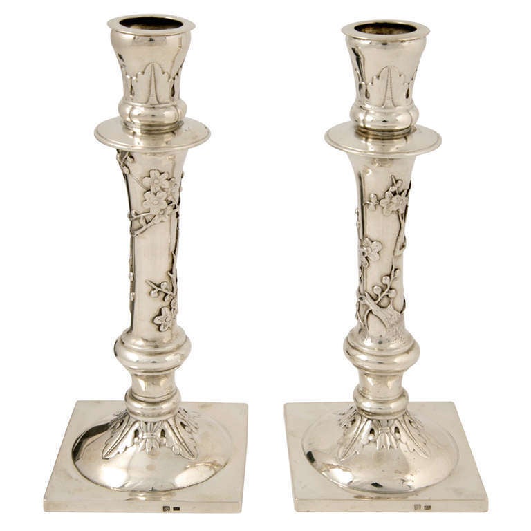 A Pair of Chinese Export Silver Candlesticks, made by Sing Fat of Hong Kong, circa 1890. They are decorated with acanthus leaf to the capital and base, and prunus to the stem.
The candlesticks are 18.5cm high and weigh 337gms.