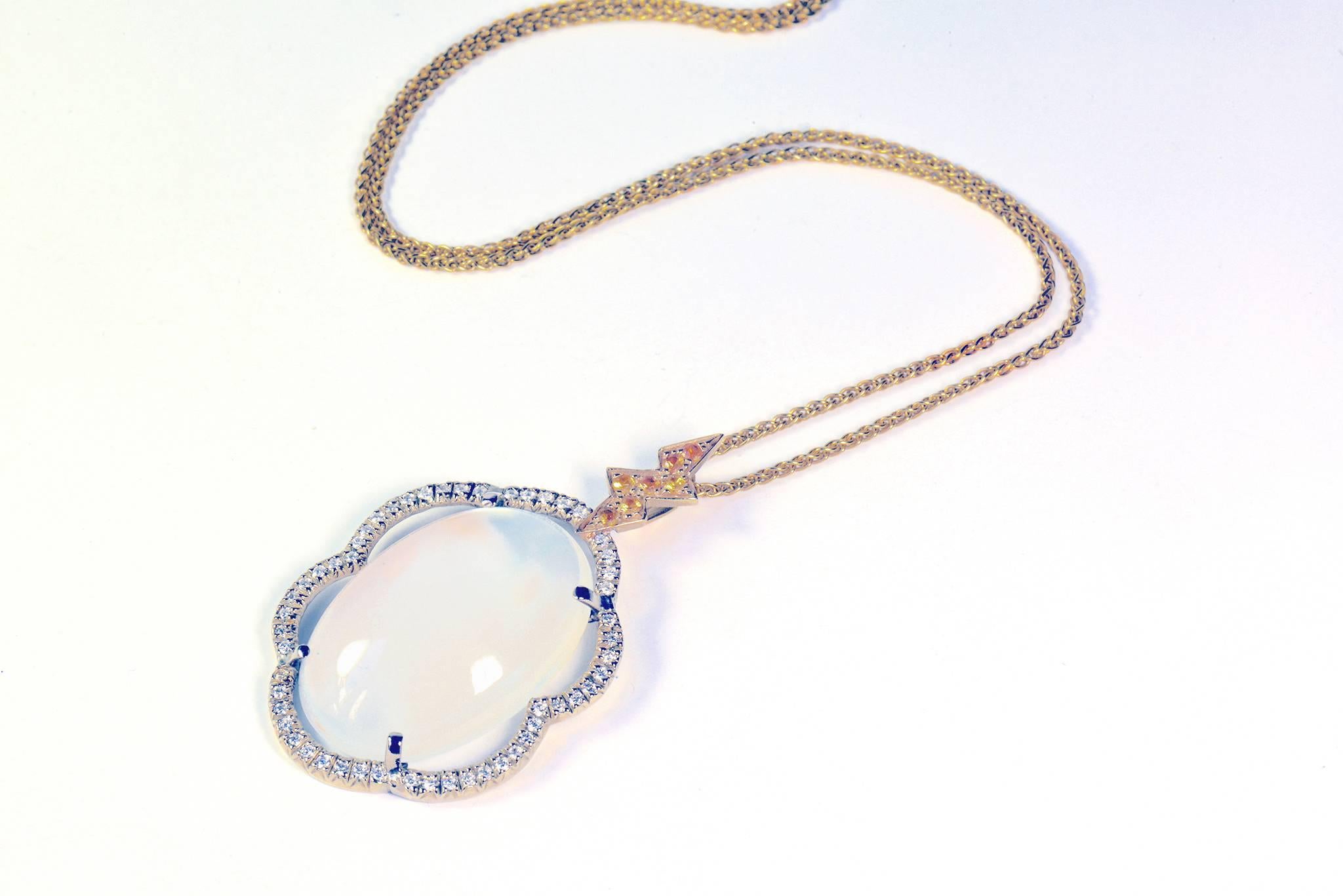 A romantic pendant with a rare moon stone cabochon, finely set with diamonds on a cloud motif. The elegant loop represents a flash of lightning with a yellow sapphires set, suspended on a yellow gold 40cm chain.
Price without local taxes.