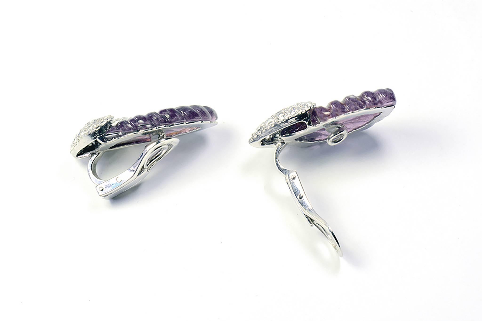 These ear clips represent engraved purple tourmaline leaves shaped, 
 25.45carats. The platinum attachment paved with white diamonds, 
 3.90carats.
18K white gold and platinum.
French assay mark and signed
Price without local taxes