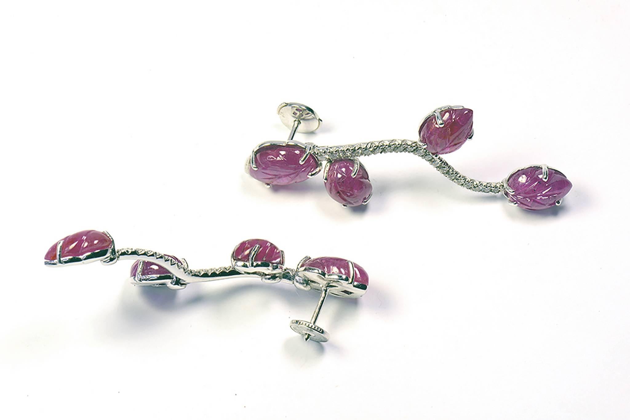 These unique 18K white gold earrrings have been created from an original vine stalk drawing based design. The eight engraved rubies adorning this model have a total weight of 17.18carats. You have 0.55 carat white diamonds on the stalk.
French