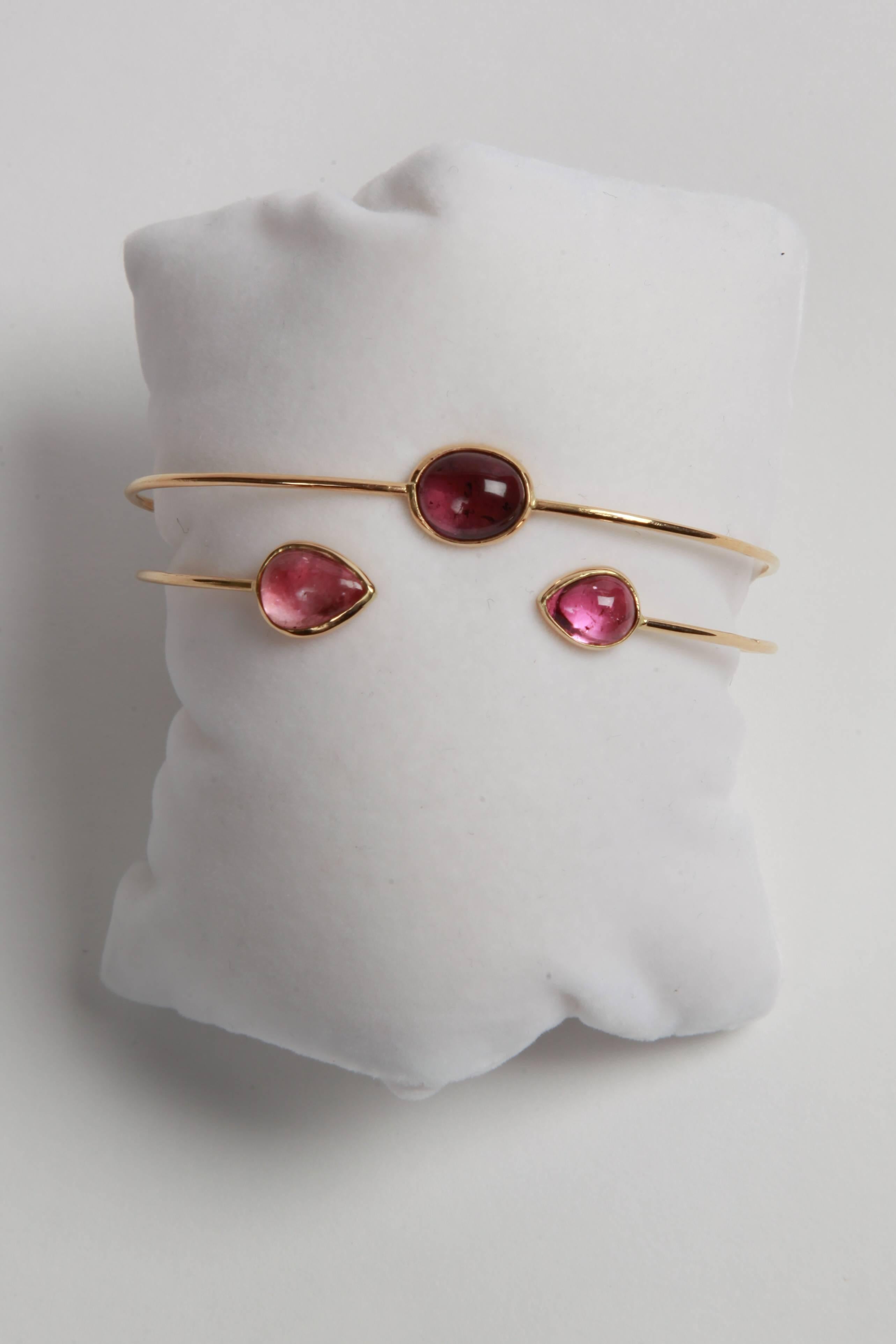 Two 18k oval rigid bracelets, both set with pink and purple tourmaline cabochons, total weight: 9.50carats, total weight: 8.44grams.
Can be sold separatly.
French assay mark, created by Marion Jeantet.
Price without local taxes.