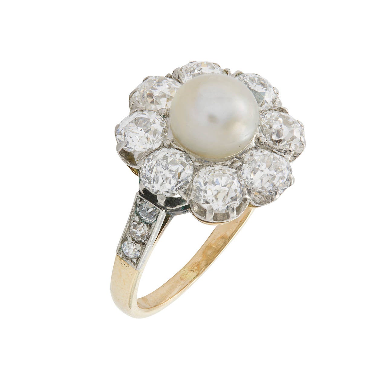 A Victorian pearl and diamond cluster ring, the central bouton pearl surrounded by eight old brilliant-cut diamonds estimated to weigh a total of 1.5 carats, claw-set in silver backed with yellow gold,  with diamond-set shoulders, circa 1880.