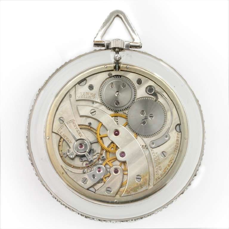 A magnificent Art Deco Cartier pocket watch, the circular rock crystal watch comprising an engine-turned silvered dial, marked Cartier Paris, with outer black Arabic minutes track within a white enamel border with yellow gold Roman numerals, the