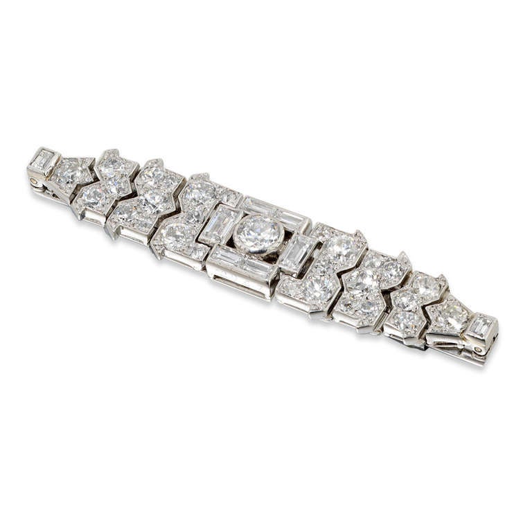 A Cartier Art Deco Fermoir de Corsage Diamond Brooch, the sprung flower holder set with brilliant and baguette-cut diamonds on a brooch fitting, diamonds estimated to weigh a total of 1.65 carats, signed Cartier, London, circa 1927.