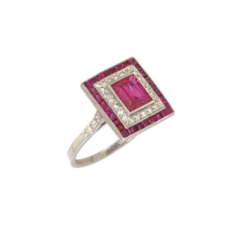 An Art Deco ruby and diamond square cluster ring, the central rectangular step-cut ruby estimated to weigh 1ct, accompanied by GCS Report, stating to be of Burmese origin with no indication of heat treatment, set to the centre of an old-cut diamond