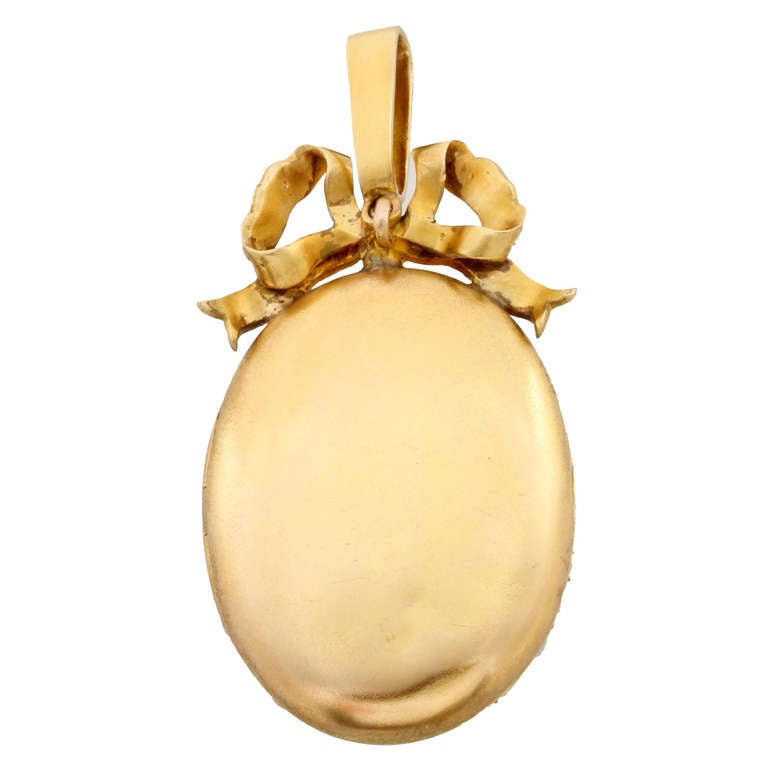 A Victorian oval natural pearl locket, the locket pave-set throughout with natural pearls, measuring approximately 3mm in diameter, and natural seed pearls, with a seed pearl-set bow surmount and pendant loop, all set in yellow gold with hinged