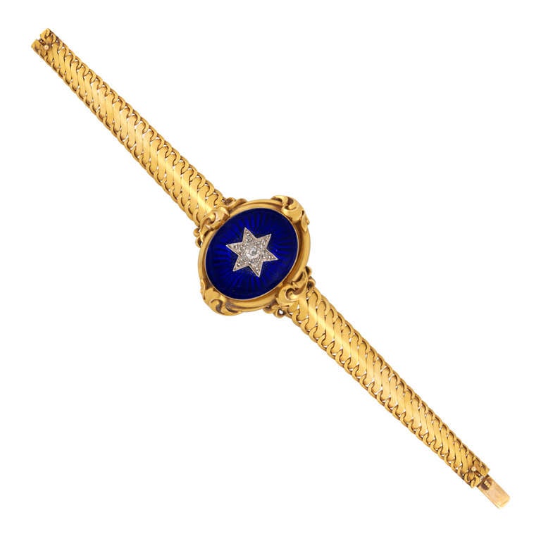 A Victorian diamond and royal blue enamel bracelet, the oval centre piece set with an old cushion-shaped diamond, with rose-cut diamonds forming a star motif, all grain set in silver, on a royal blue enamel ground, within  a yellow gold border with