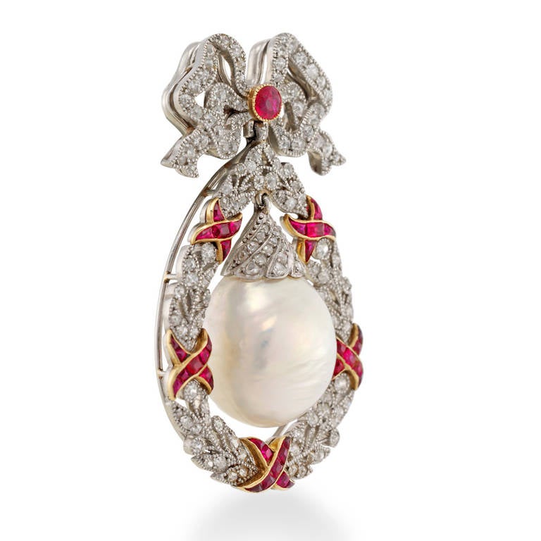 A Belle Epoque natural pearl, ruby and diamond brooch/pendant, the drop-shaped pearl estimated to weigh approximately 14 carats, accompanied by SSEF report stating to be natural of freshwater origin, with a fluted design rose-cut diamond-set cap,