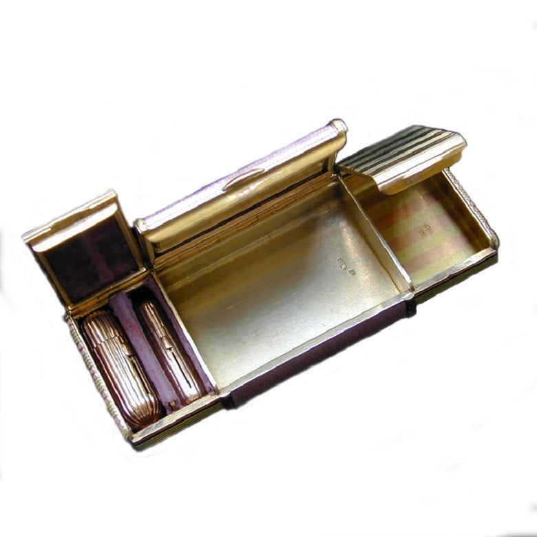 Ein Fabergé-Etui aus zweifarbigem Gold und lila Email von Werkmeister A. Holmstrom, das rechteckige Etui misst etwa 11 cm in der Breite, das zentrale Puderfach ist mit durchscheinendem lila Email auf einem wellenförmigen Guilloché-Grund in einer