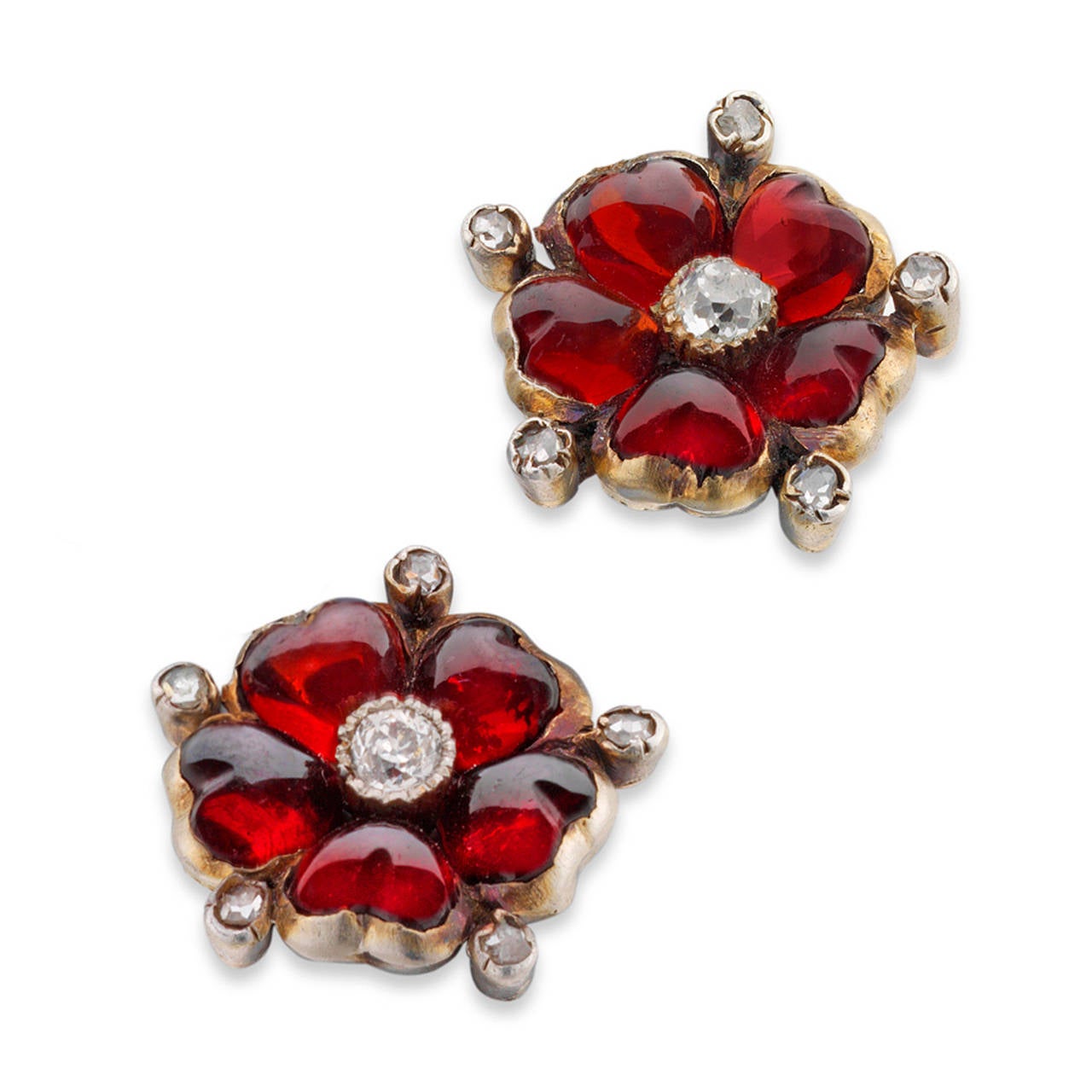 A pair of Victorian garnet and diamond flower earrings, the flower motifs centred with an old-cut diamond surrounded by cabochon garnet petals interspersed with rose-cut diamonds, all set in silver to a yellow gold mount with peg and scroll