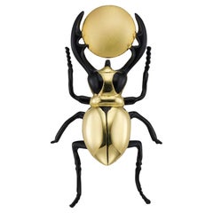 A gold and black enamel scarab beetle/Ra-Khepri brooch
