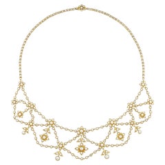 An Edwardian split pearl and gold festoon necklace