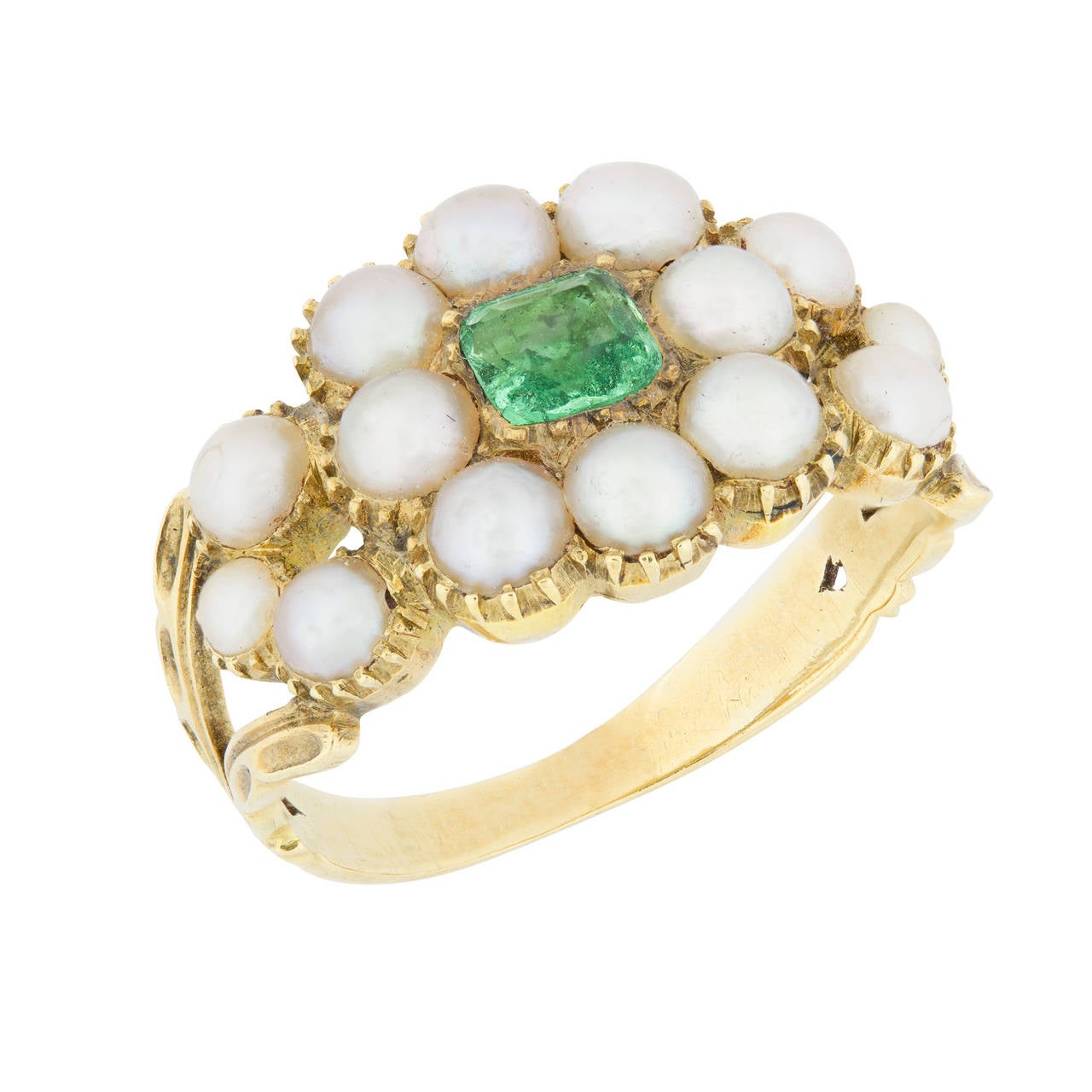 A Regency pearl and emerald cluster ring, the square step-cut emerald measuring approximately 4 x 4mm, set to the centre of a cluster surround of eight natural pearls measuring approximately 3.4mm in diameter, three pearls set to each shoulder, all
