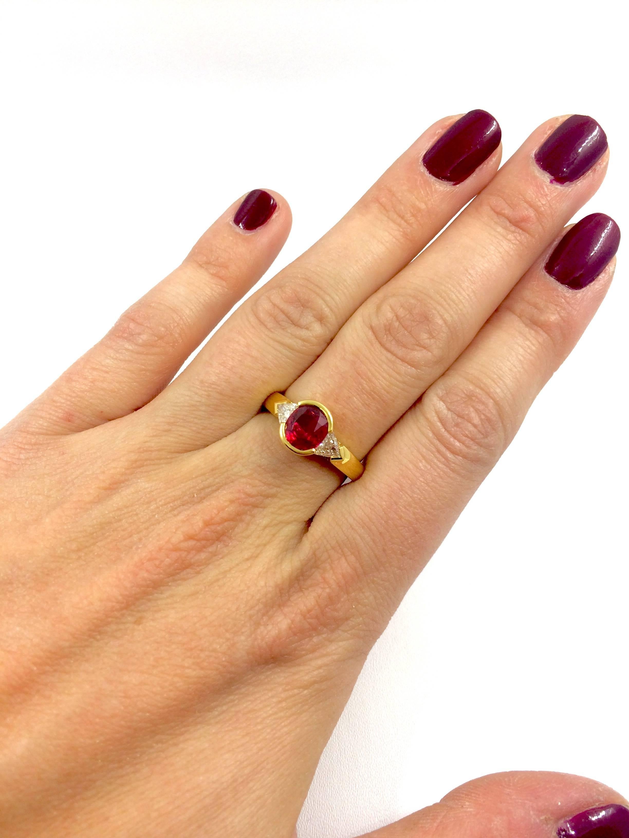 A yellow gold ring set in the middle with an exceptionnal Burma Ruby surrounded by a trillion cut diamond on each side.
Ruby Weight: 1.61 carat
Total Diamonds Weight: 0.40 carat
Diamonds Quality: F/VS
Finger Size: 6.5 can be sized