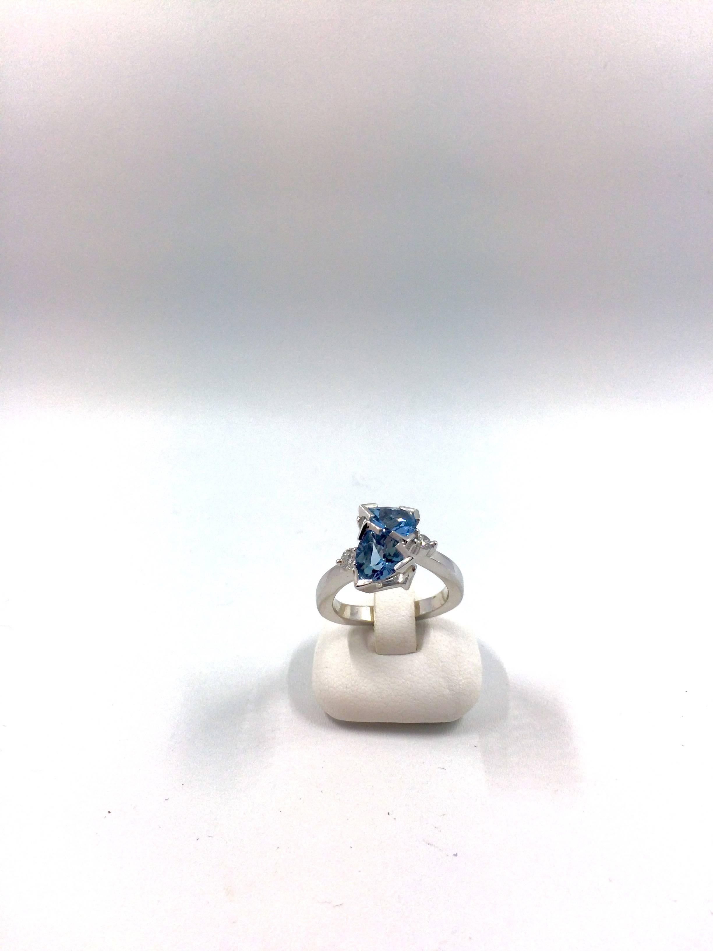 A white gold bypass ring set with two aquamarine and a brilliant cut diamond on each side. The ring is an unique creation entirely handmade.
Aquamarine Total Weight: 2.06 carat
Aquamarine Origine: Brasil
Diamonds Total Weight: 0.18 carat
Net Weight: