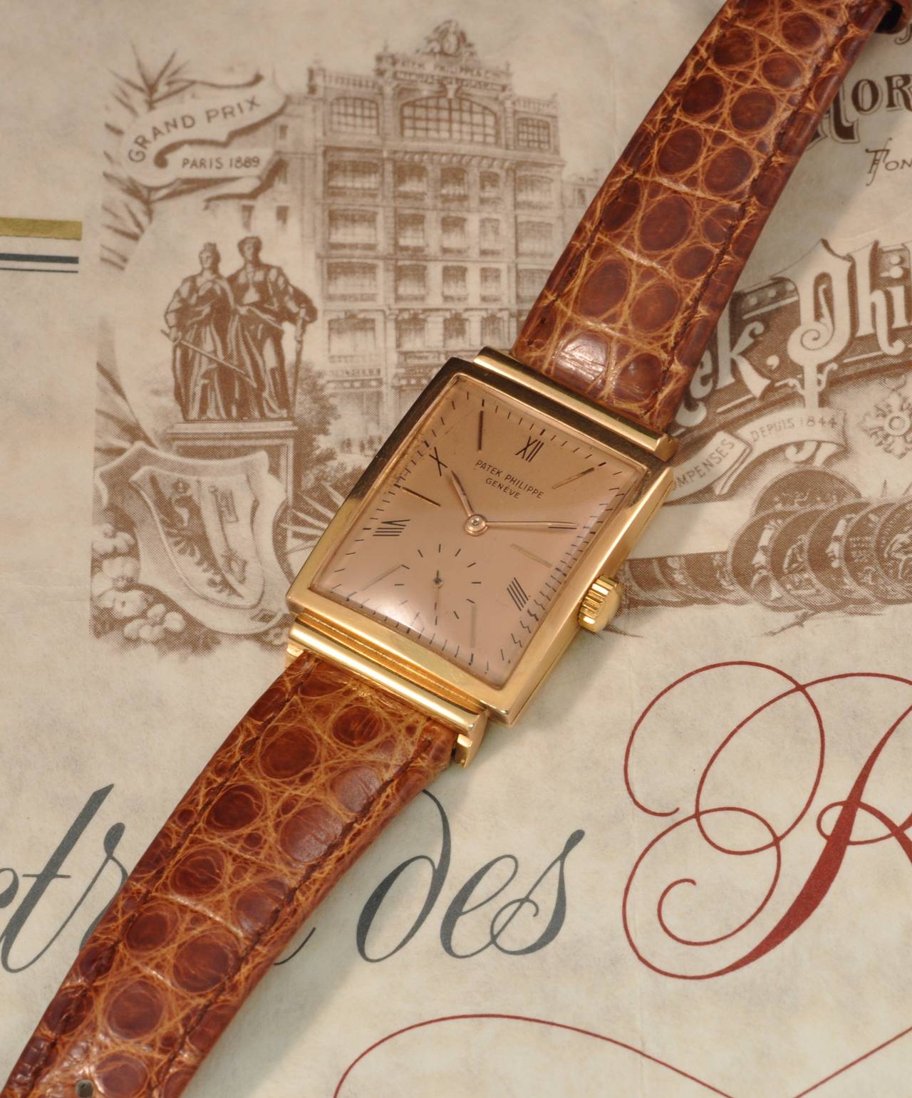 Fine and rare 18k rose gold rectangular manual winding wristwatch with pink dial. Extract from the Archives Patek Philippe.