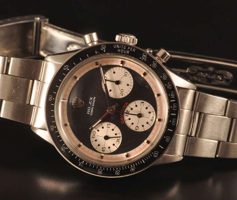 Rolex stainless steel Paul Newman Daytona chronograph wristwatch, manual-wind with black dial and silvered subsidiary dials.