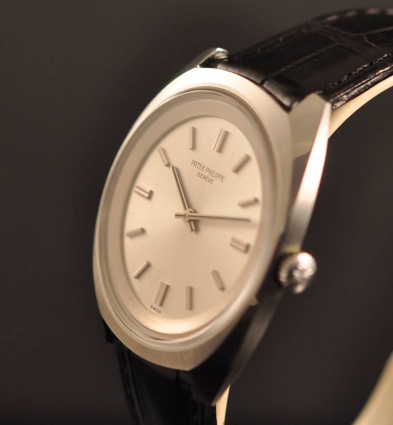Patek Philippe stainless steel tonneau wristwatch with manual-wind movement and silvered dial, circa 1970s.