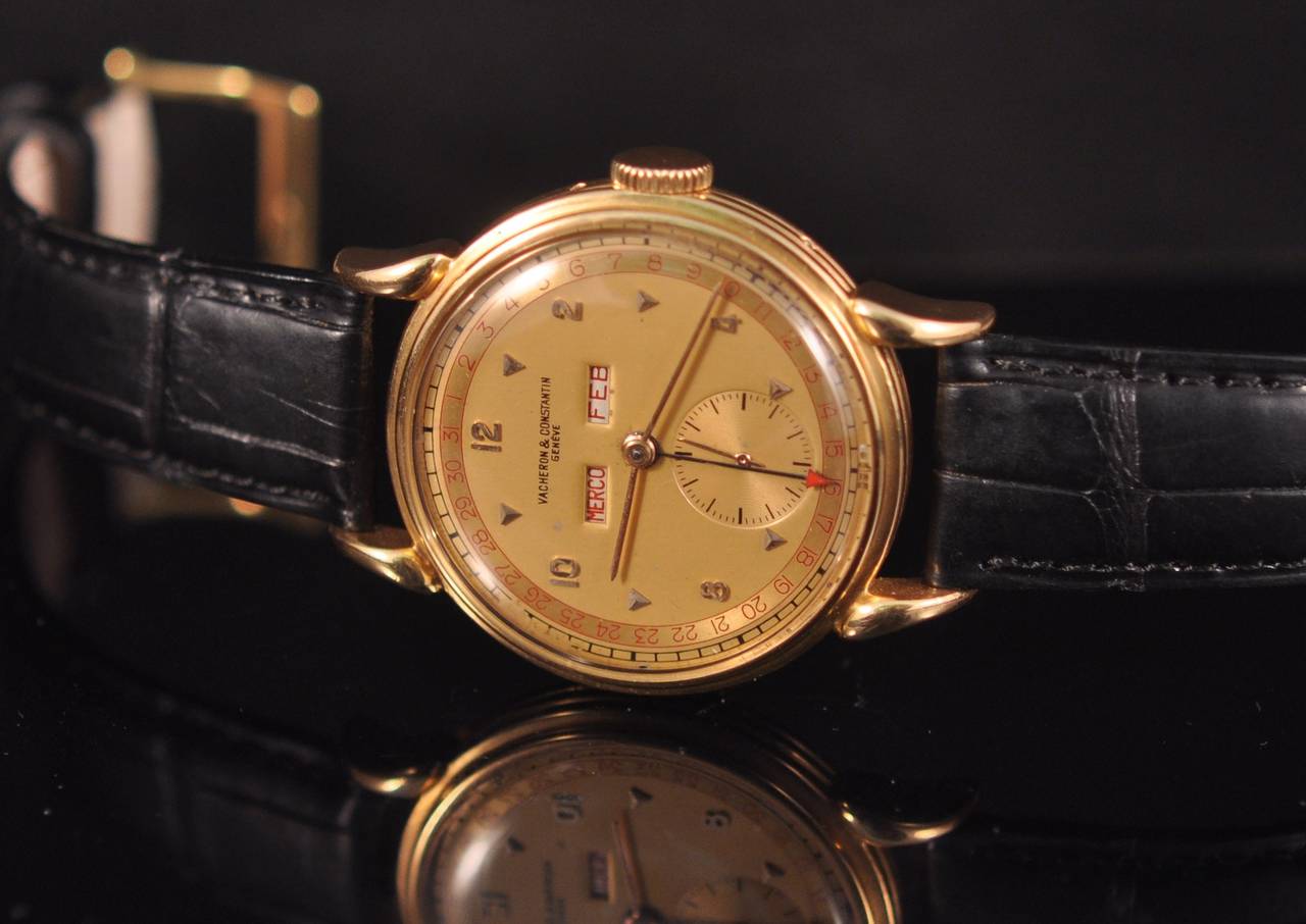 Rare and fine 18k gold manual winding wriswatch with day, date and month.