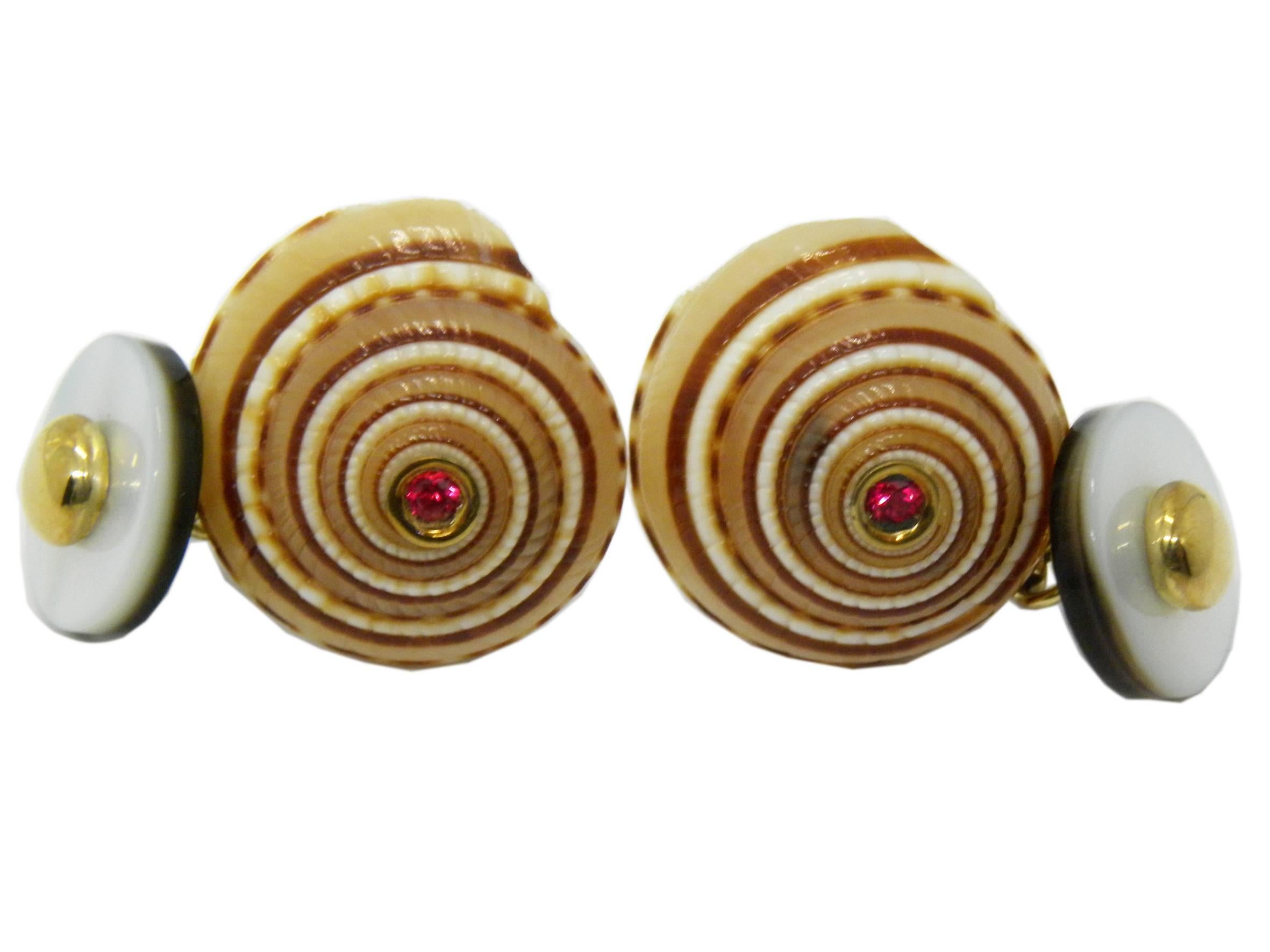 One-of-a-kind chic cufflinks featuring two round red spinel, Architectonica Jutea Round Seashell 18C Yellow Gold setting, white and grey mother-of-pearl back. 
The seashell back is hand enamelled.