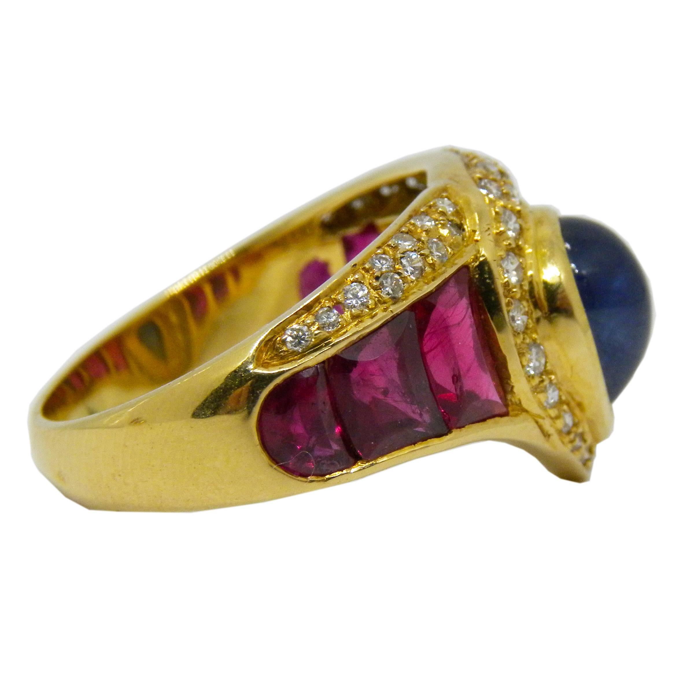 Unique original 80's italian cocktail ring featuring one 1.35 Carat Natural Drop Cabochon Blue Sapphire 1.17 Carat Ruby Cabochon Baguette 42 White Diamond  for a total amount of 0.65 Carat,18 Carat yellow gold setting.
Us Size 5.50
French Size