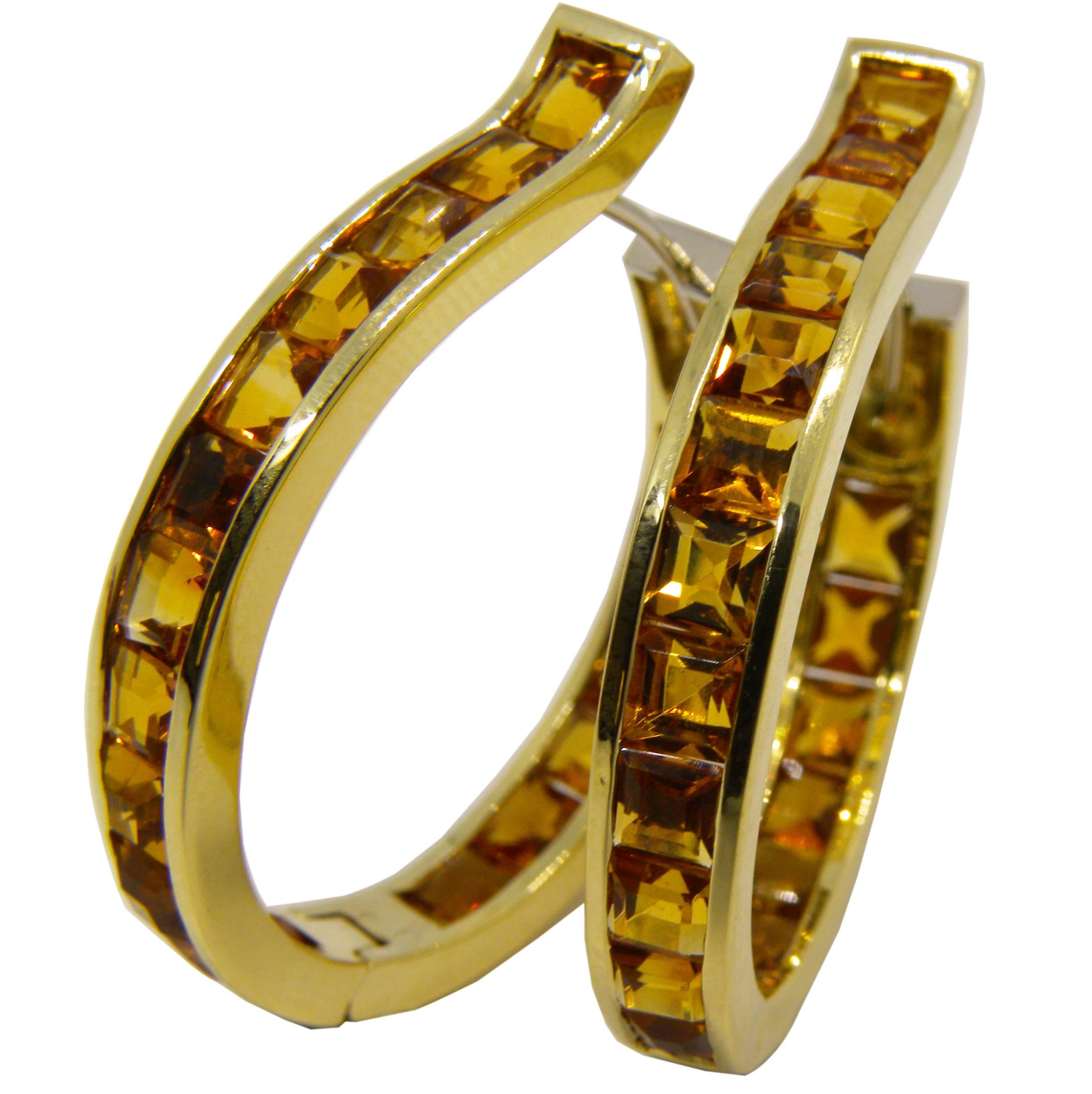 Dazzling, unique, magnificent oval hoop earrings featuring 8.20 Carat calibrated square cut citrine, 14.80 grams 18 Carat Yellow Gold setting 