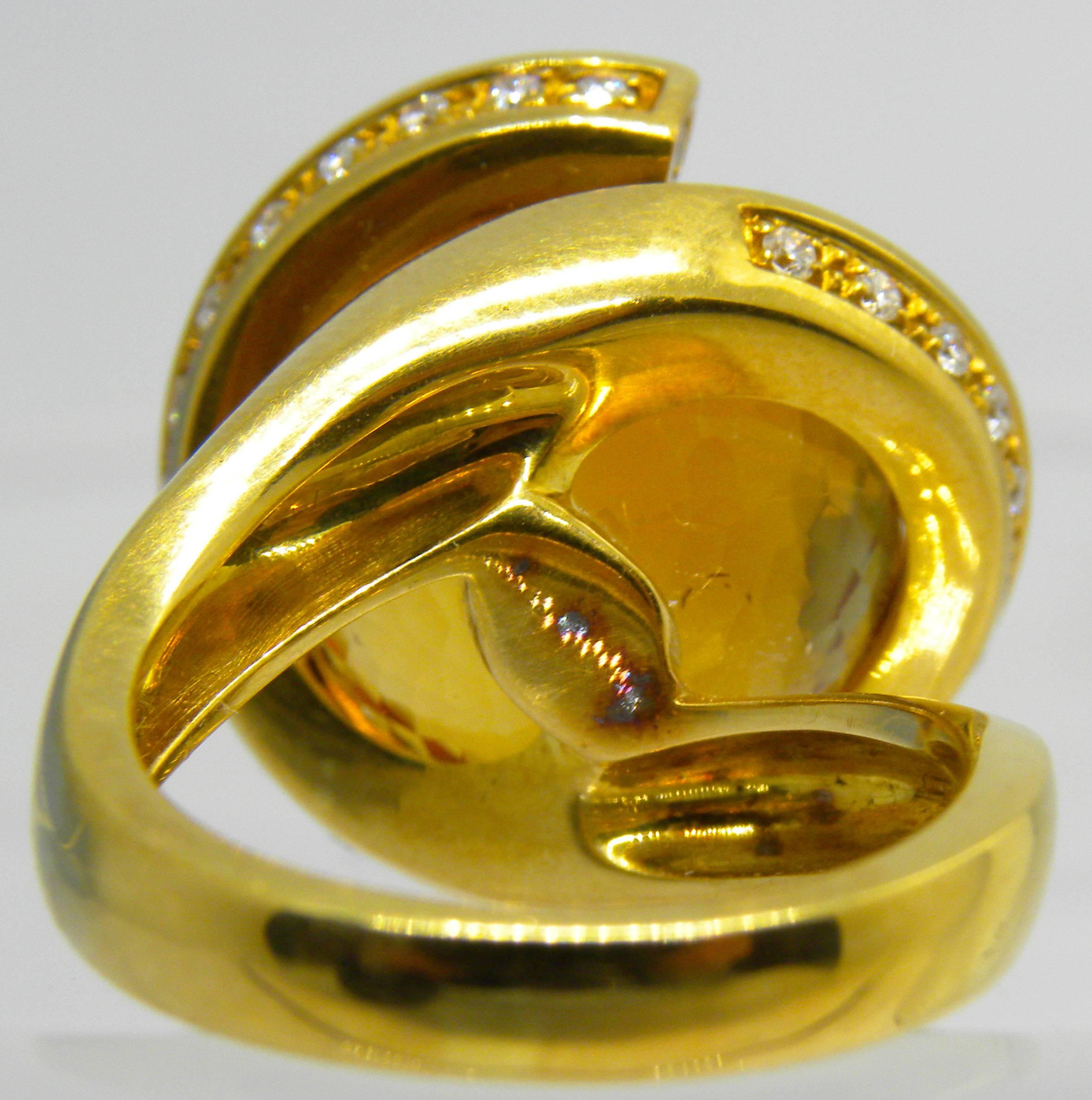 Iconic, Unique yet Timeless 25.70 Carat Natural Madeira Hand Inlaid, Hand Faceted Citrine Ball, diameter 0.59 inches(15mm), in a 0.65Kt White Diamond 18 Carat Yellow Gold Handcrafted and Sculptural Helix Setting.
In our fitted burgundy leather