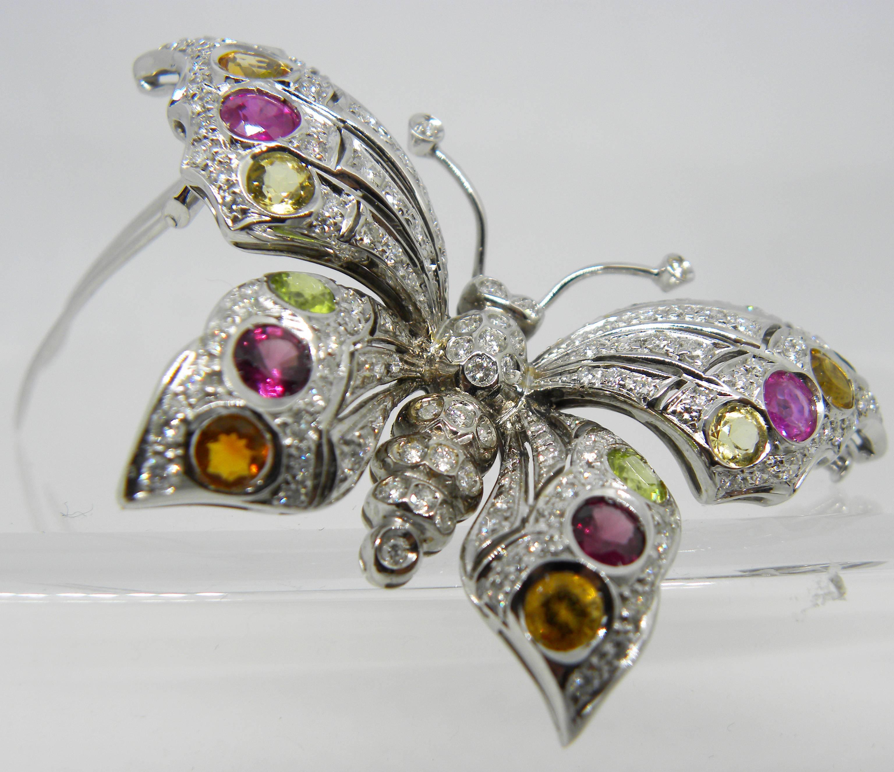 One-of a-kind Original 80's, 2.45 Carat D-E, IF Top Quality White Diamond, 1.30 Carat Red Pink and Green Natural Tourmaline, 7.20 Carat Peridot, Citrine Quartz, 18 Carat White Gold Setting Extraordinary  Brooch.
This unique jewel can be worn also as