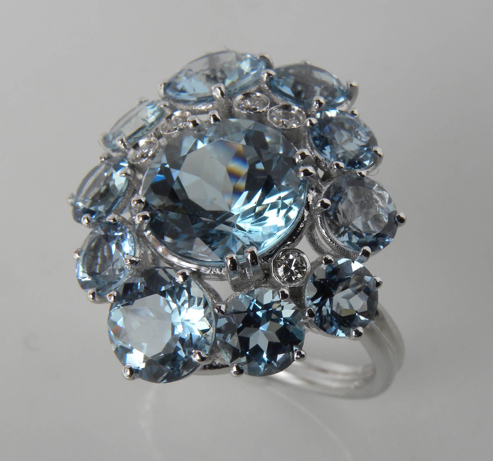 Sumptuos cocktail ring featuring 10 brilliant cut Aquamarine and 5 top quality white diamonds surrounding a round brilliant Aquamarine of 3.26 Carat, 18 Carat white gold setting.  All aquamarines, top quality, are from Brazil.
US size 7.25
French