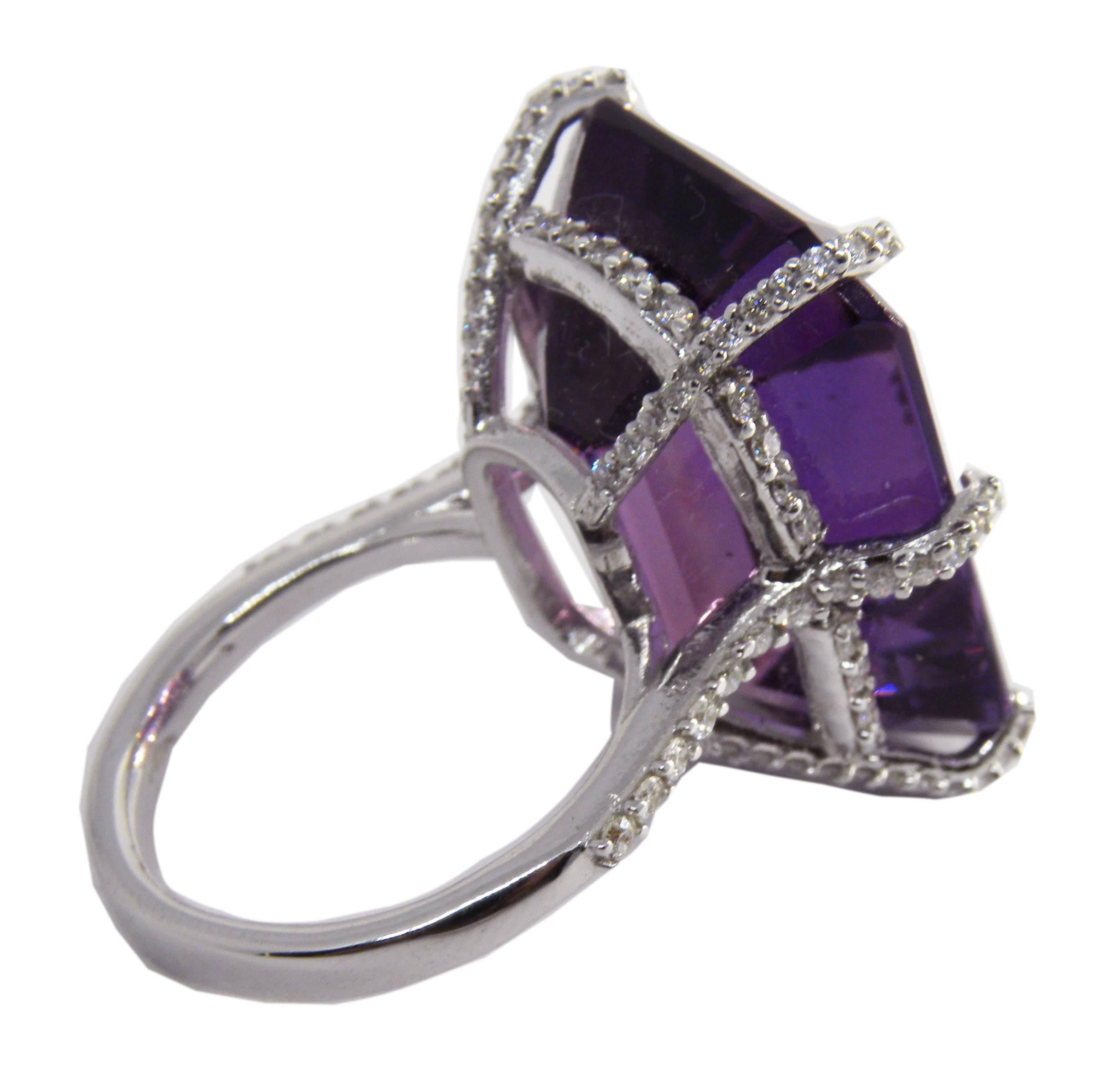 Sumptuous one-of-a-kind Cocktail Ring featuring a 31.76 Carat Emerald Cut natural Amethyst  in a white diamond 18 Carat  white gold Setting
Amethyst 23.80x17.60mm
White Diamond Round brilliant cut 1.05 Carat
18k White Gold 8.20g
Us Size 6 3/4
French