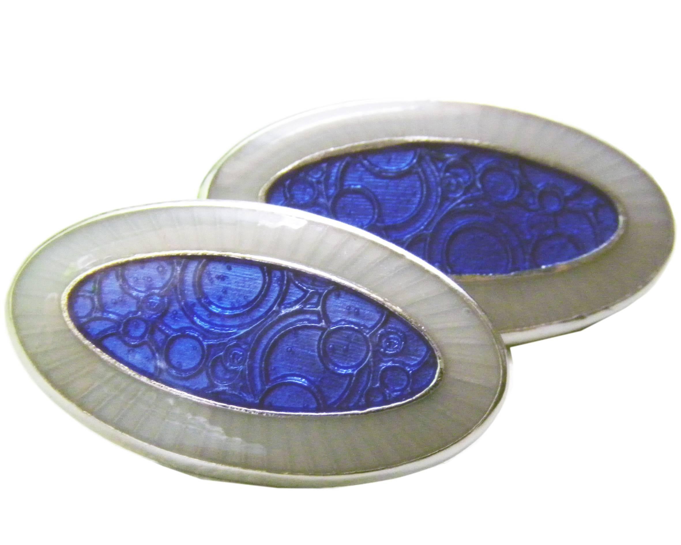 Unique Oval Hand Enamelled blue and light grey sterling silver cufflinks, champlevé technique.
This piece is a limited edition of an 1920s pair of cufflinks found in Berca's archives.

