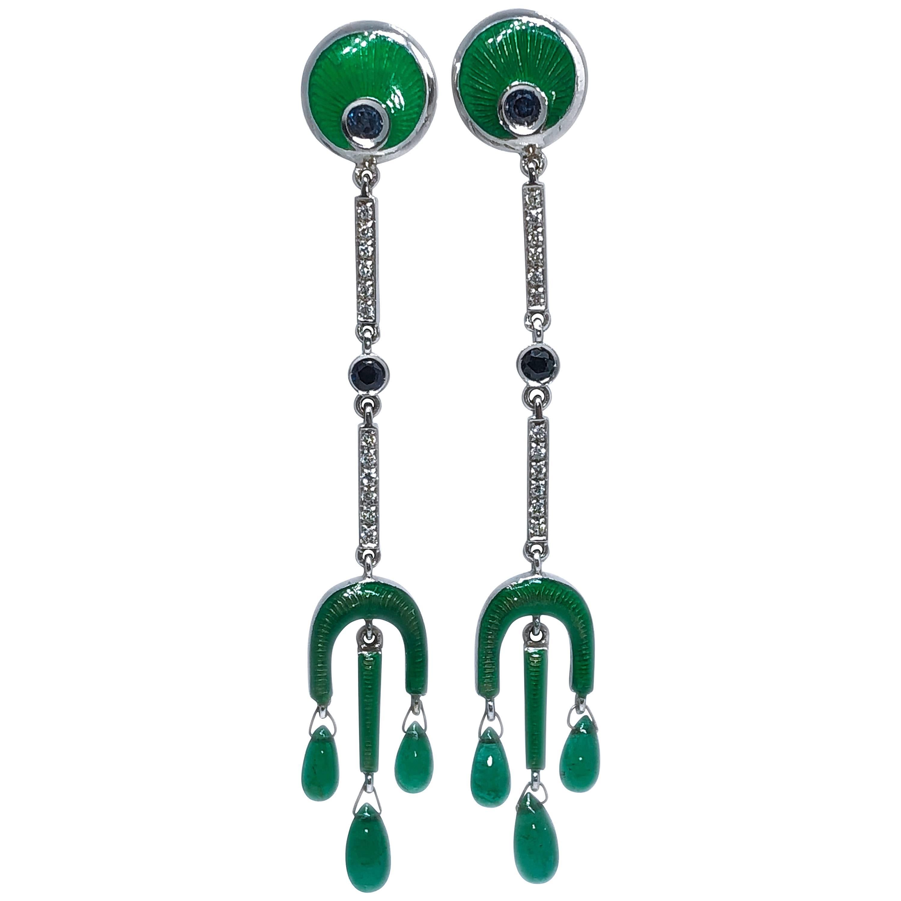 Chic, yet Timeless, One-of-a-kind Drop Emerald Earrings, Hand Enamelled with the antique champlevé technique featuring 0.55 Carat round Blue Sapphire, 3.80 Carat Emerald Drops 0.24 Carat White Diamond, 18k White Gold Setting.
Lenght 2.95 inches,