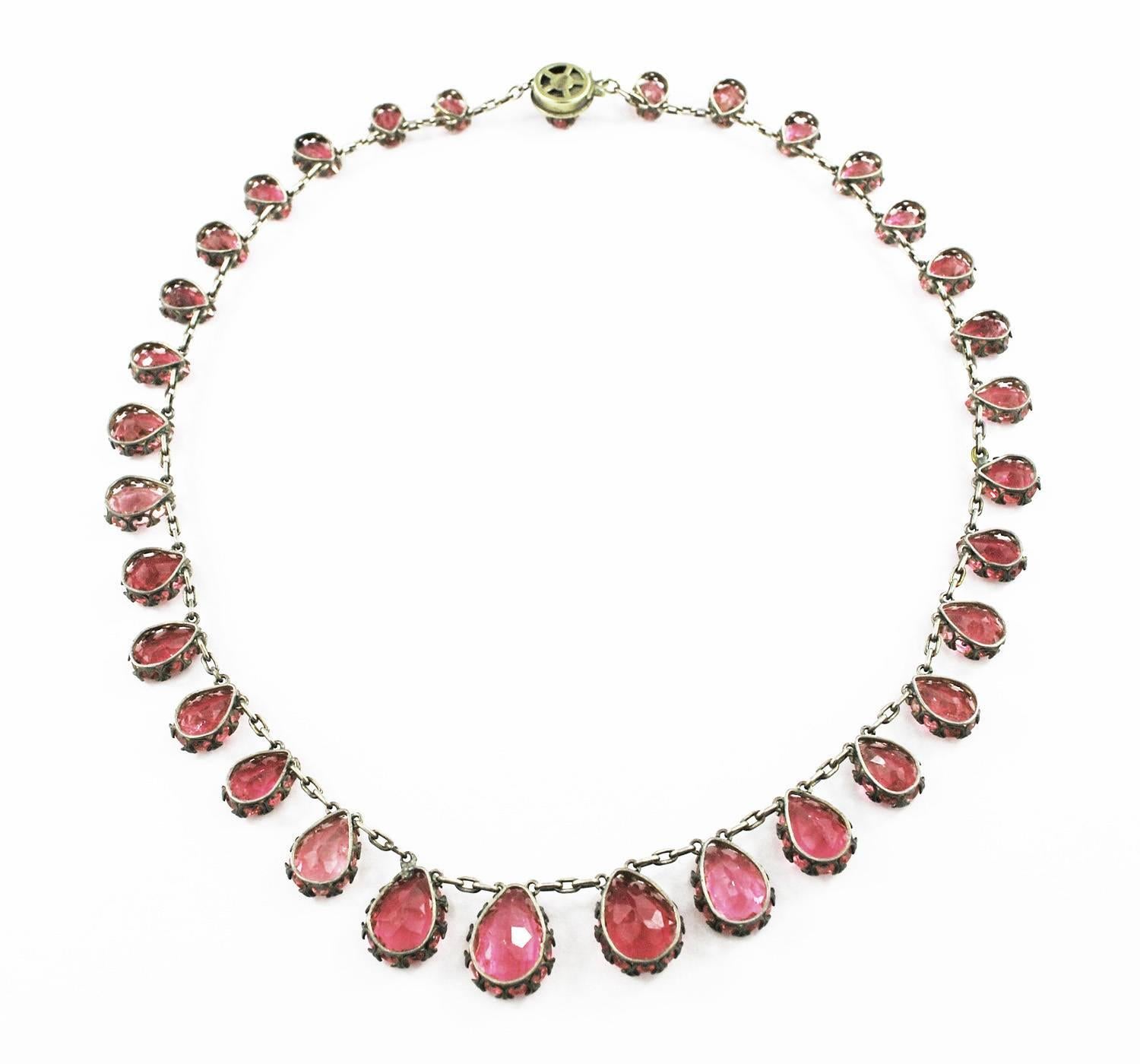 A rare natural pink tourmaline necklace from the end of 19th century. Necklace has 33 pear cut tourmalines with a total weight of 65 cts. The stones are in open back silver settings. 

The largest center tourmaline is 15 mm x 10 mm. Stones color