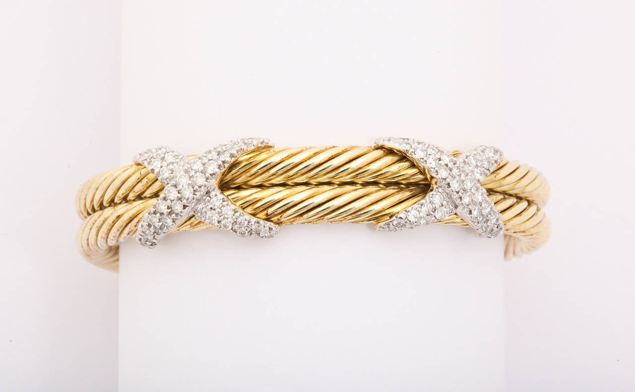 David Yurman two row 14k gold cable braclet with two diamond X's set in white gold. 

WIdth - 15mm total

Inside dimensions 2.25