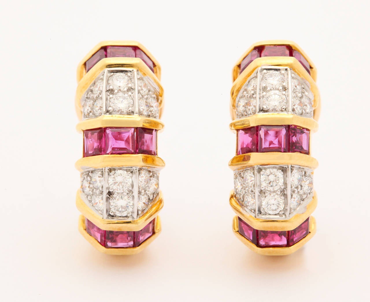 Classic diamond and ruby earrings. The stones in these earrings are of very high quality. The rubies are square cut and have a beautiful red color. The diamonds are round cut stones, very clean, white and really sparkle. The diamonds are mounted in