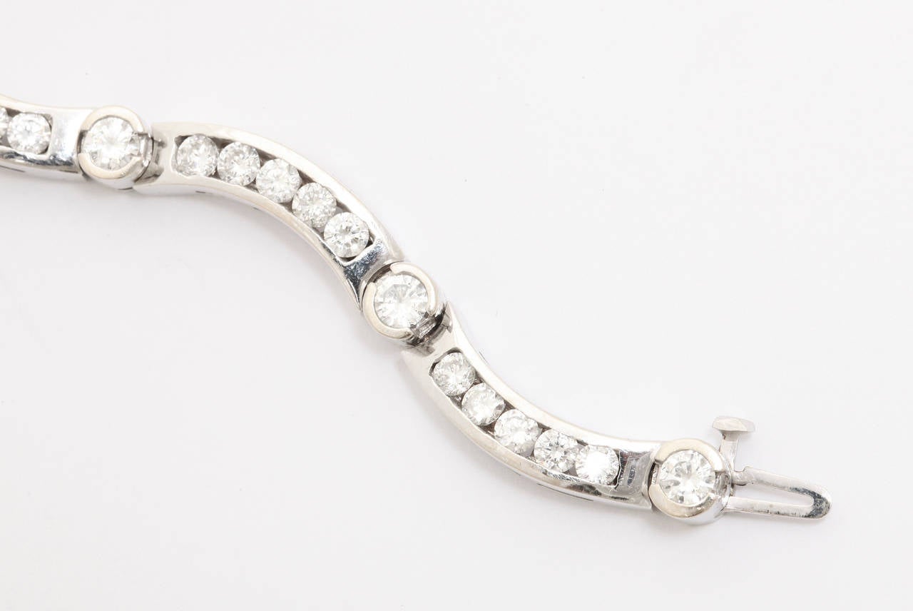 Contemporary diamond bracelet set in 18k white gold. Total weight of the diamonds is approx. 4.5 carats. The diamonds are of good quality and are clear, white and sparkle. A fun bracelet that would look great by itself or with other bracelets or a