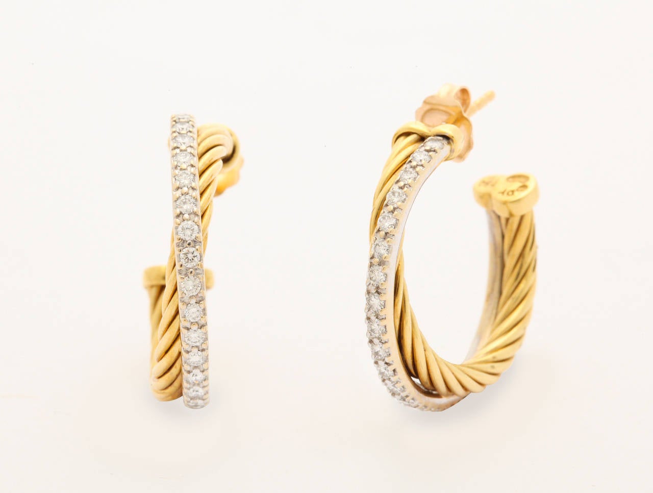 Simple and elegant David Yurman earrings in 18K in a cross over design. The diamonds  are set in white gold and have .72 carats of diamonds. Diamonds are clear, white and really sparkle. The yellow gold hoop is in the classic Yurman cable design.