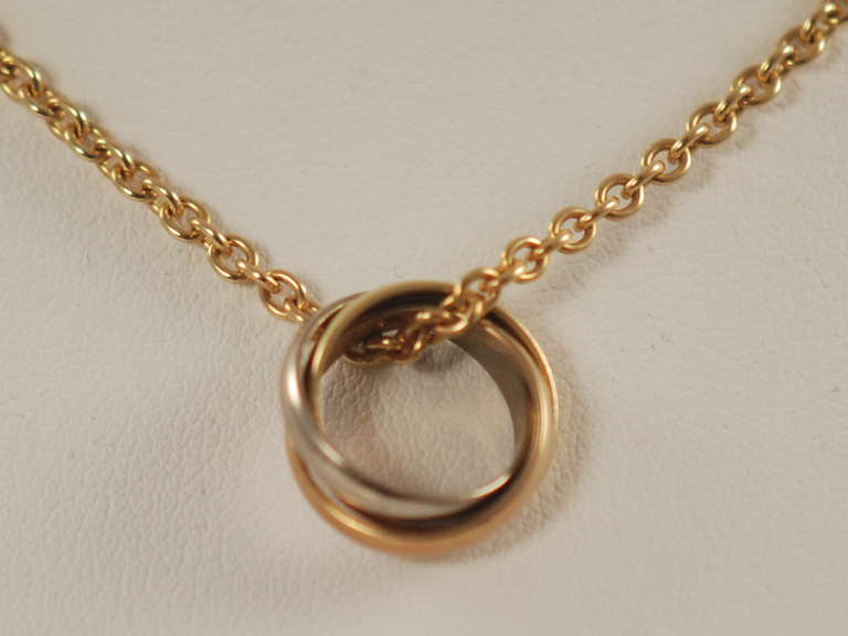 Since 1924 Cartier has been making Trinity rings. It is an enduring design. This necklace is the Baby Trinity Necklace and retails on the Cartier website for $1990.00. The ring is three colors of gold; yellow, pink and white representing love,
