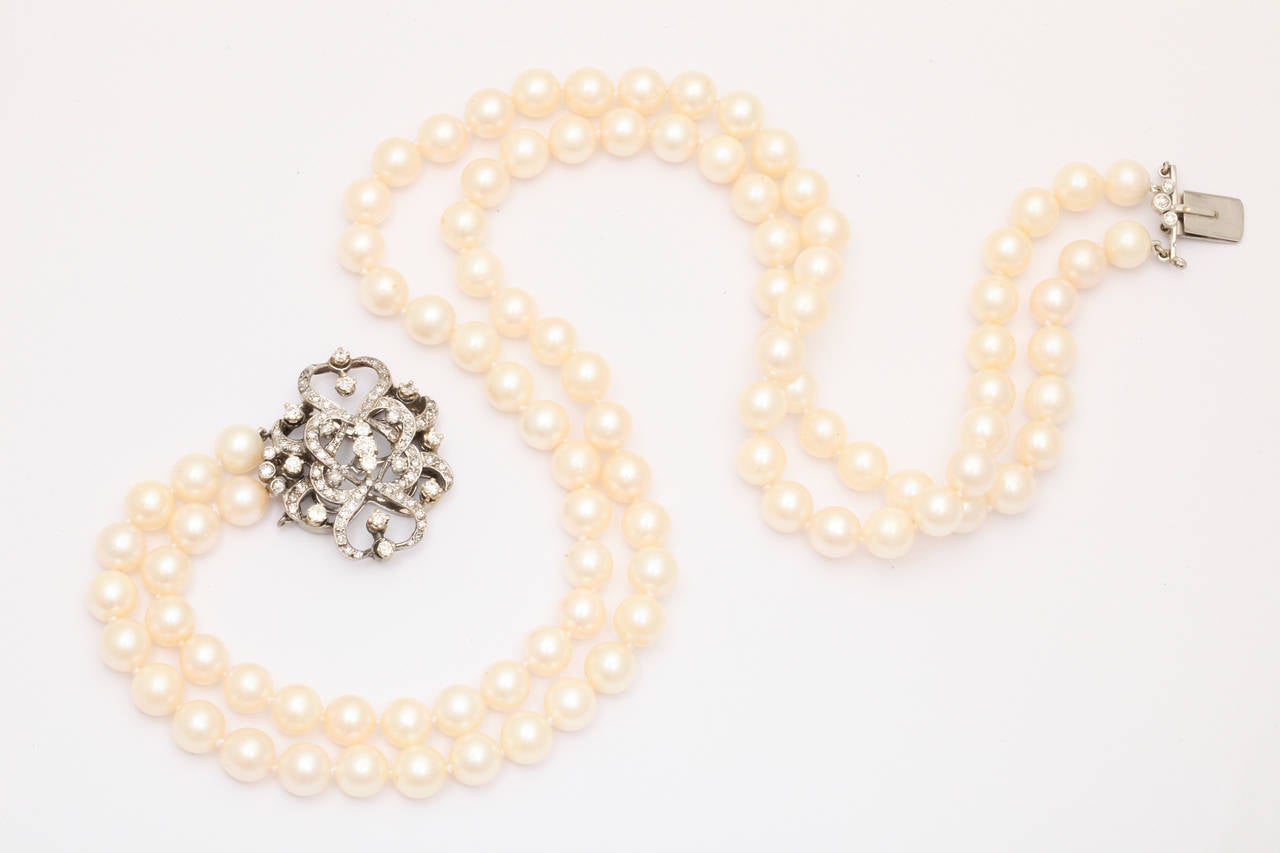 Double strand pearl necklace wit beautiful antique style 14k white gold clasp with approx. 2 carats of white diamonds that really sparkle and are full of life.  The pearls are about 7.5 - 8mm and have a nice luster and cast pink. Including the