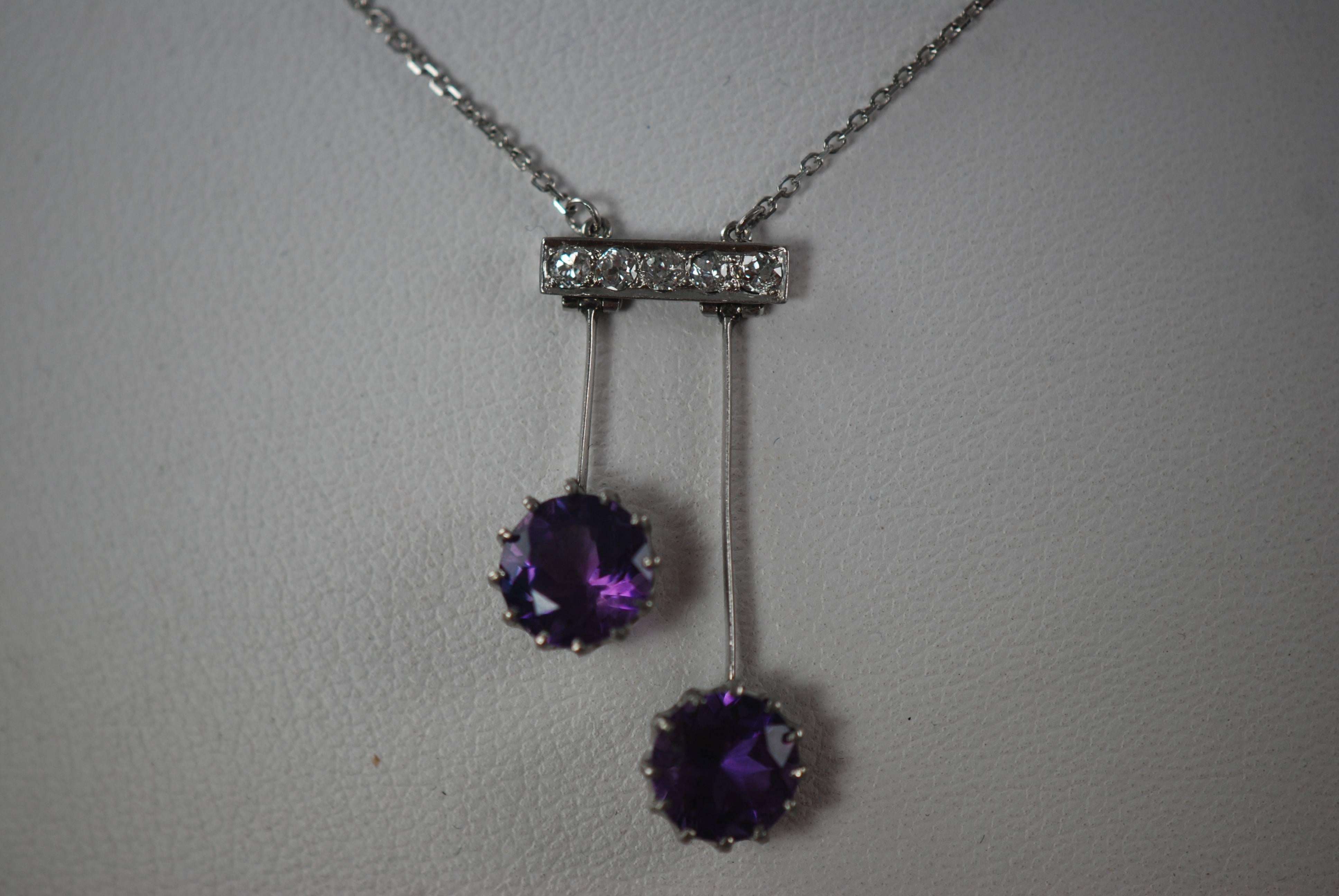 14k white gold lingerie pendant set with 20 pints of mine cut diamonds. The amethysts are clear and well matched.They measure about 0.25