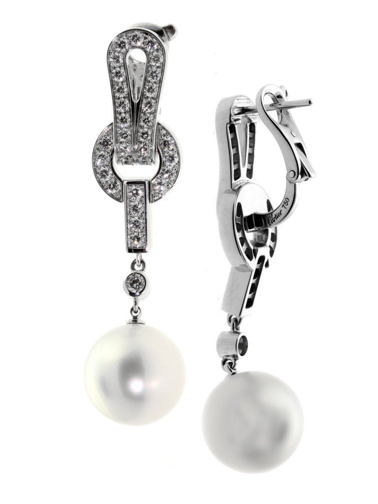 Stunning Cartier Agrafe earrings featuring a Vvs1 E-F Color Round Brilliant Cut Diamonds followed by a 12mm Pearl. The earrings measure 1 3/4″ in length and have a total weight of  16.4 grams.

Cartier Current Retail Price: $24,000 + Tax