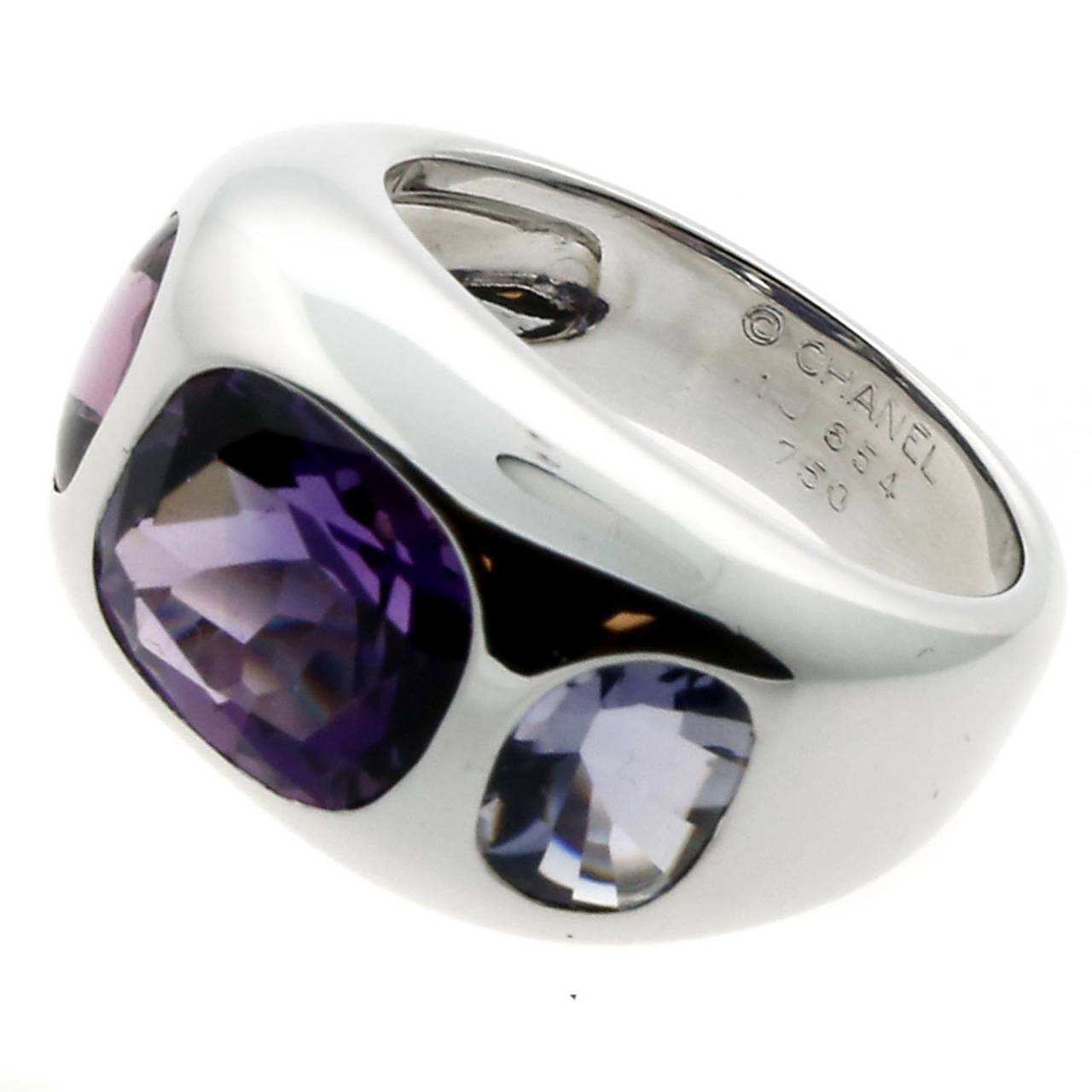 A fun authentic Chanel cocktail ring featuring vibrant tourmaline, amethyst, and iolite gemstones set in 18k white gold.

Size: US 4 1/4
Dimensions: The ring measures 10mm wide  (.39″ Inches)

Inventory ID: 0000025