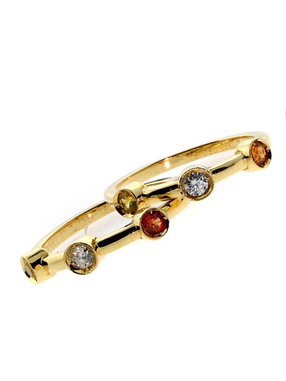 Playful Diamond and Sapphire rings by Chanel, crafted in 18k Yellow Gold both featuring a Round Brilliant Cut Diamond followed by a Yellow and Orange Sapphire. Sz 54, US 6 1/2, measuring 4mm each.