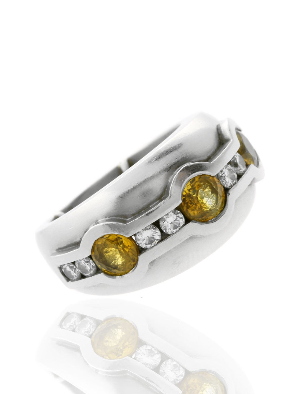 A beautiful dome style ring by Barry Kieselstein-Cord featuring 8 Round Brilliant Cut Diamonds, set in between 3 Yellow Sapphires. The ring is crafted in Platinum, Sz 5, and has a total weight of 24.1 grams.