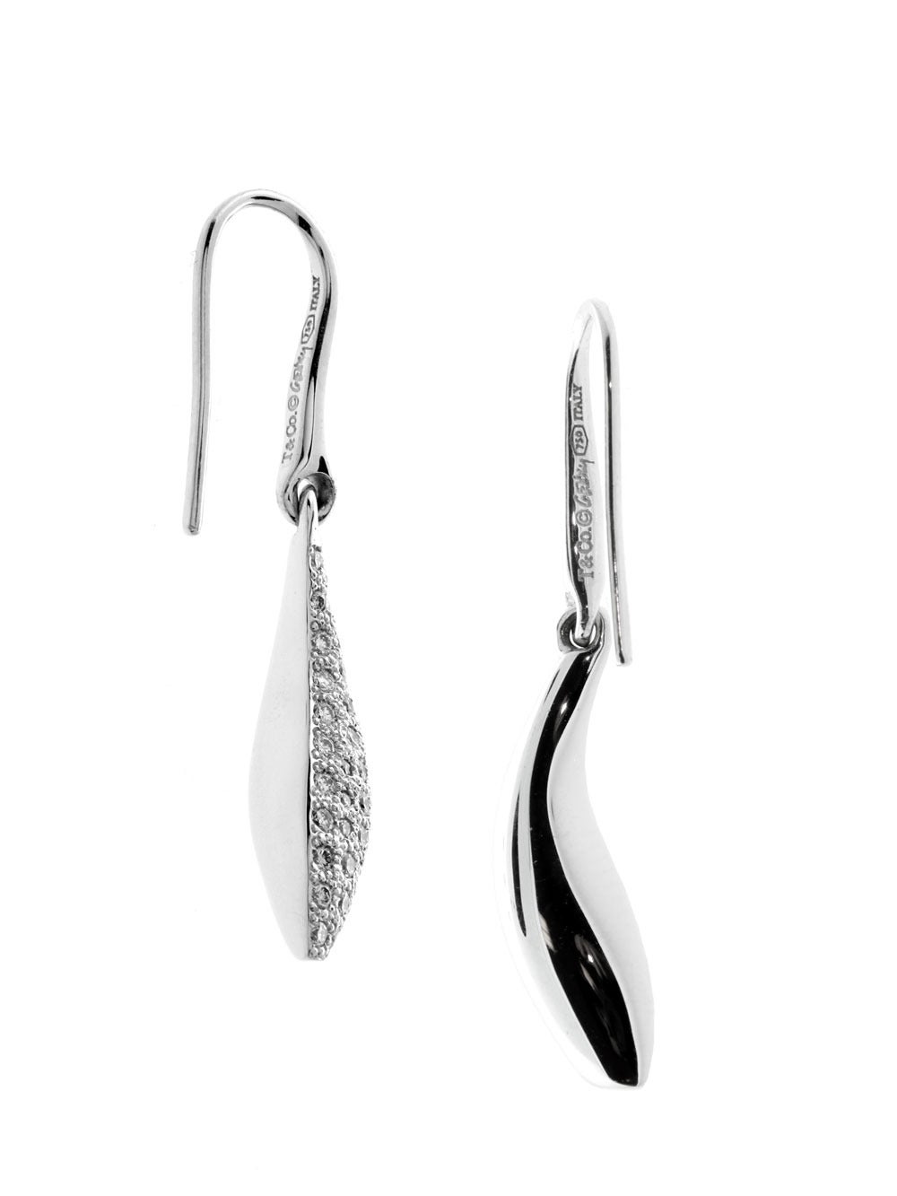 Graceful and flowing, evoking images of oceanic beauty, the Fish earrings by Tiffany & Co epitomize subtle glamour. Sculpted in smooth, glossy white gold and encrusted with .84 cts of round cut brilliant Vs1 F-G color diamonds, the clarity and