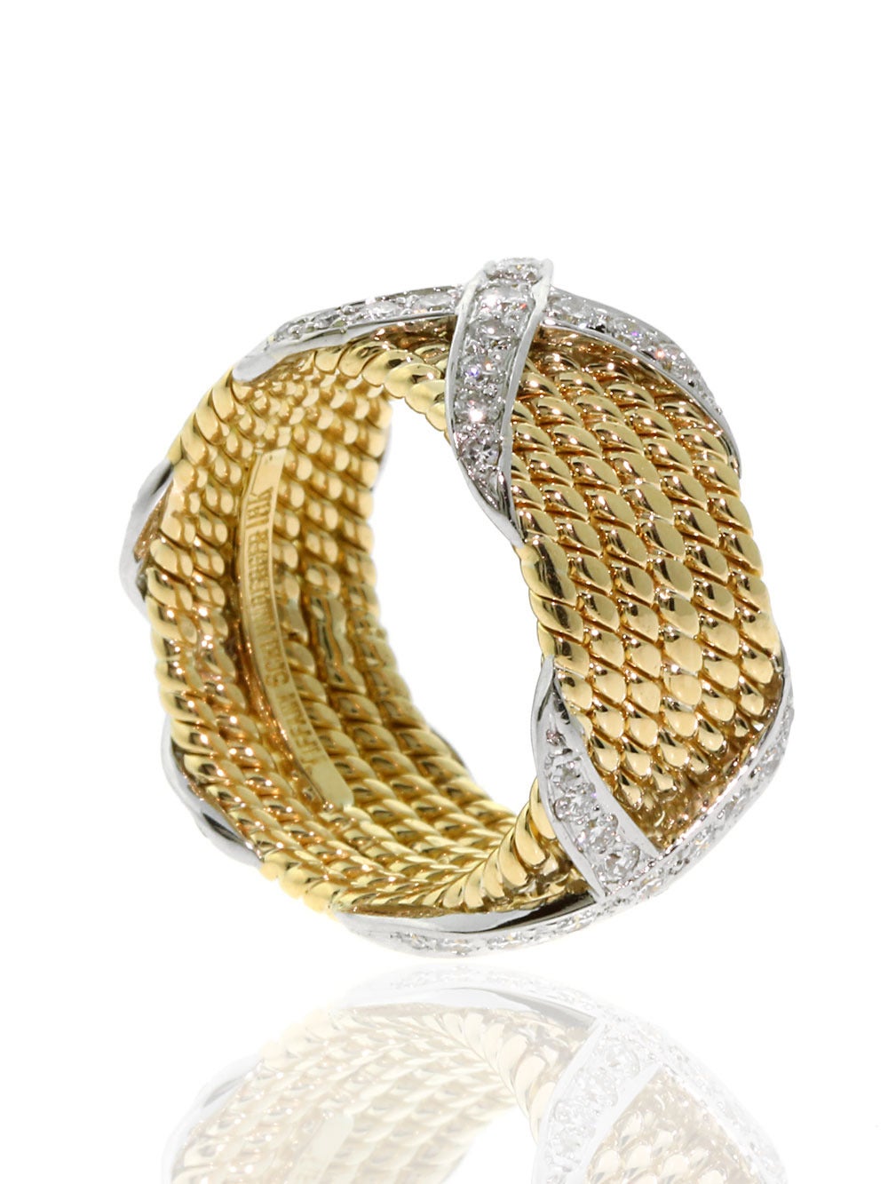 A wonderful ring by Schlumberger for Tiffany & Co. flawlessly blending 18k Yellow Gold, and Platinum. The ring measures 12mm wide (.47″), and is a size 7.