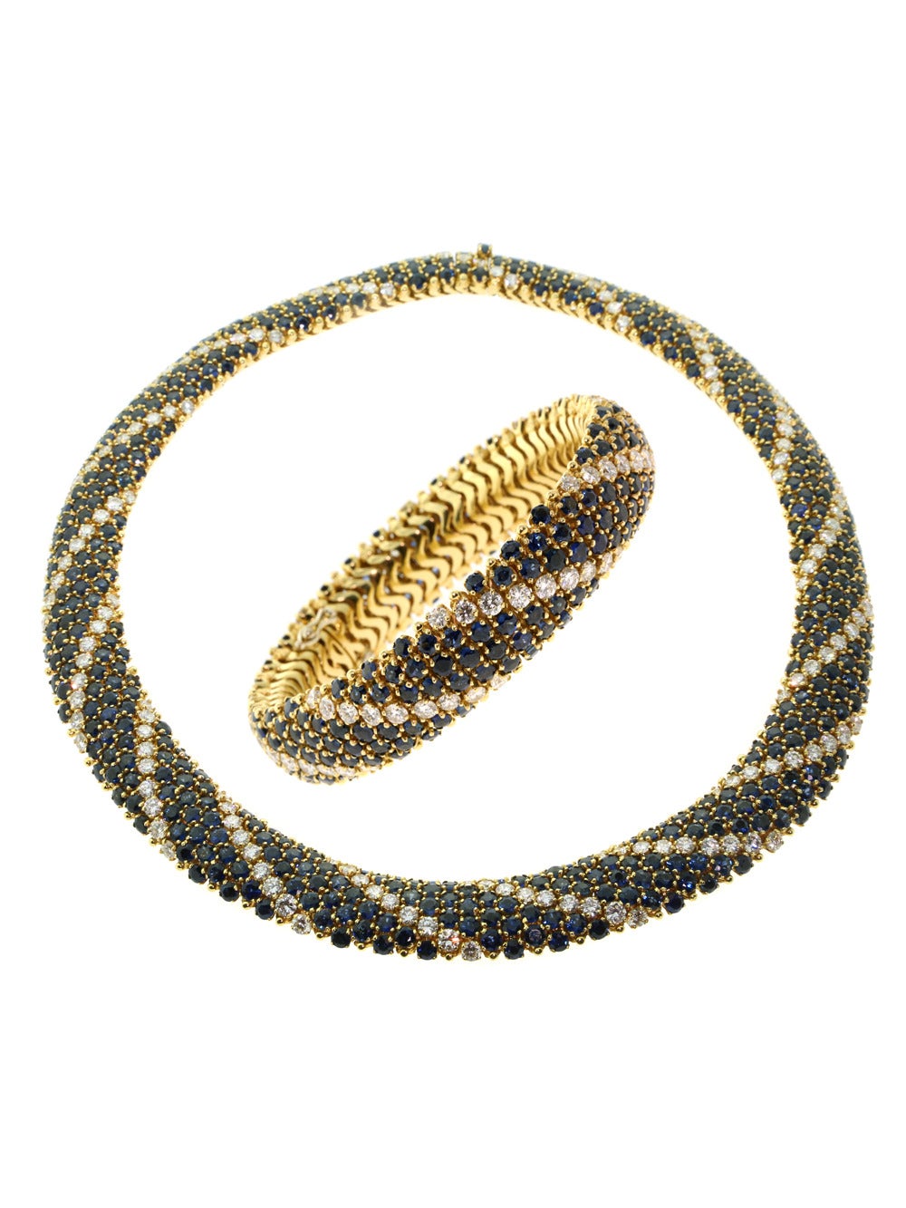 Achieve true aesthetic affluence with this stunning 18k Yellow Gold Bracelet & Necklace Set from Cartier! Boasting a jaw-dropping 103ct of brilliant blue Sapphires plus an astonishing 22ct of dazzling Diamonds, this impeccable matching Set truly is