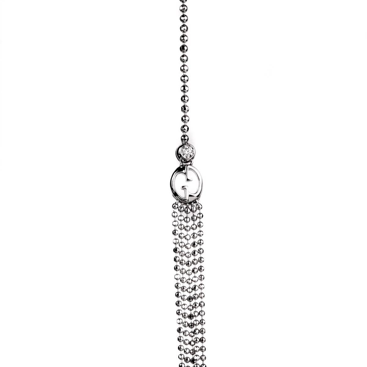A fabulous multistrand Gucci necklace featuring 2 round brilliant cut diamonds set at the top of the double G motif elegantly transforming with 5 diamond cut white gold necklaces draping the front. Necklace length: 18