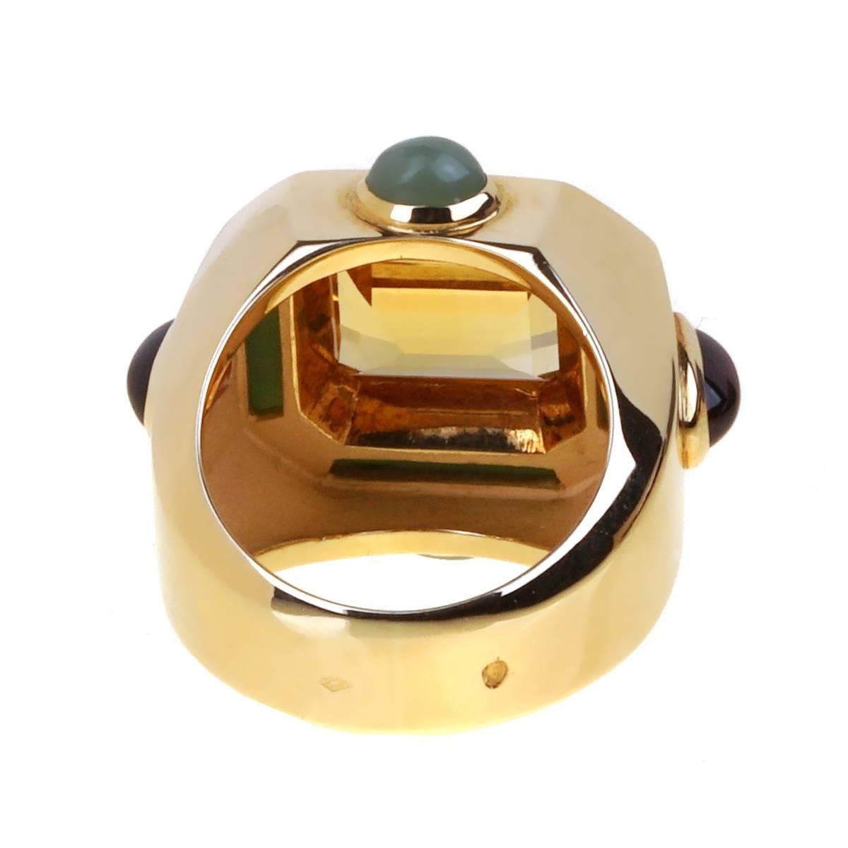 A chic Chanel cocktail ring featuring a golden emerald cut citrine, carved jade in 18k yellow gold. The ring also showcases 4 cabochon oval cut gemstones. The ring measures .85